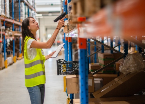Female Retail worker taking inventory in a supply warehouse
