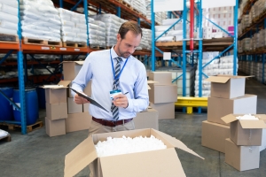 Warehouse Material Handler Checking Inventory with Clipboard