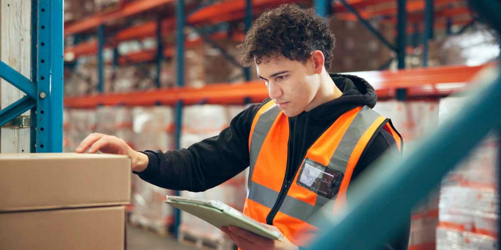 Warehouse Order Picke Checking Label Accuracy on A Box